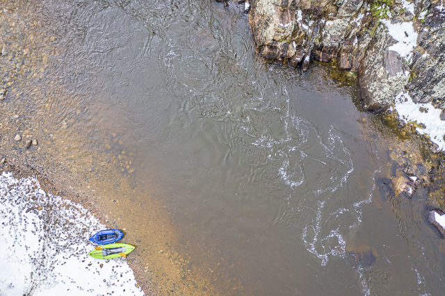 inflatable kayak and packraft on a river - aerial view