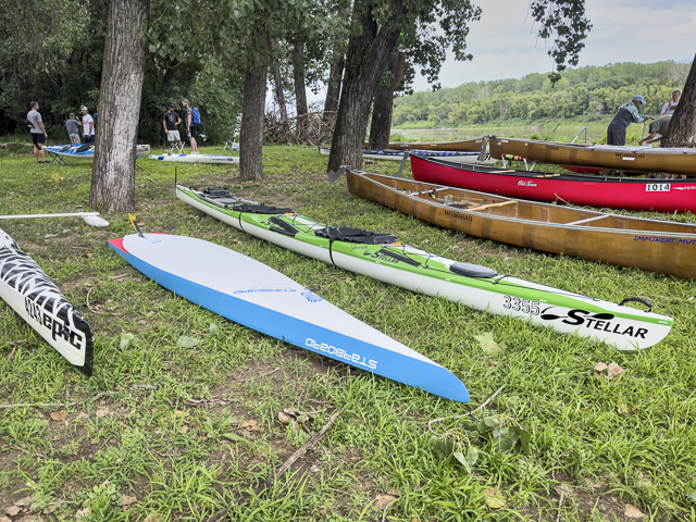 Paddlers with stand up paddleboard, kayaks and canoes at Kaw Point Park, confluence of Missouri and Kansas Rivers.