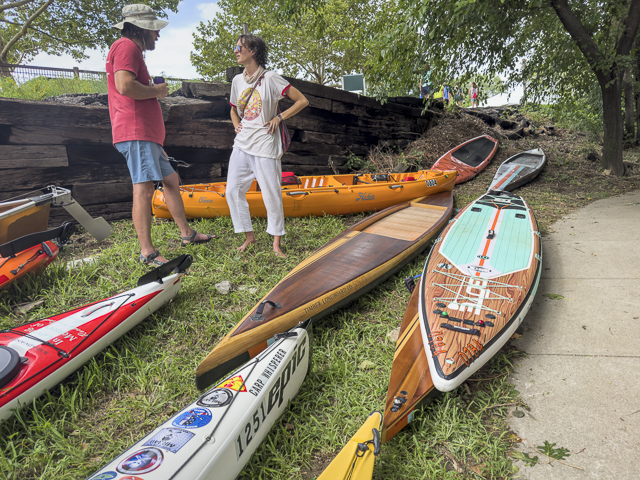 Paddlers with stand up paddleboards, kayaks and canoes at Kaw Point Park, confluence of Missouri and Kansas Rivers.