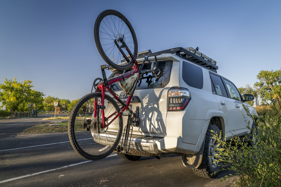Windsor, CO, USA - September 27, 2023: Toyota 4runner SUV with Trek touring gravel bike mounted with  Hornet suction cup racks by Seasucker on a rear window.