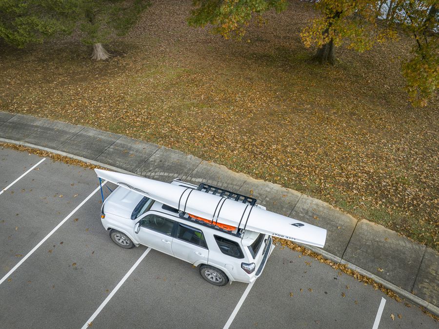 Skyway Beach, FL, USA - November 22, 2023: Toyota 4runner SUV with a rowing shell, LiteRace 1x by Liteboat on roof racks on a Florida beach.