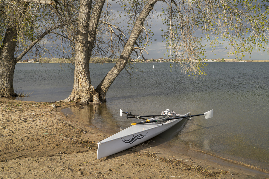 Fort Collins, CO, USA - March 1, 2024: Coastal rowing shell by Liteboat on a lake in northern Colorado in winter or early spring scenery.