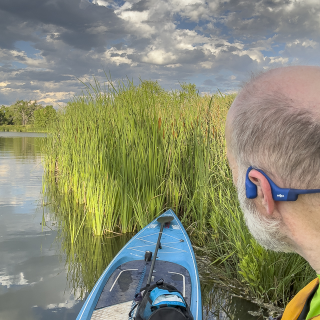 SUP paddler with open ear headphones